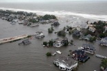 Storm surge from Hurricane Sandy beaches barrier island on New Jersey Coast. US Coast Guard