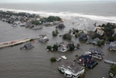 Storm surge from Hurricane Sandy beaches barrier island on New Jersey Coast. US Coast Guard