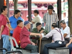 Seniors playing chess outside Chinatown's Buddha Tooth Relic Temple.