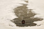 A boy swims in the polluted water of the Yamuna River to dive for offerings thrown in by worshippers amid a dust haze in New Delhi during World Environment Day in 2010.
