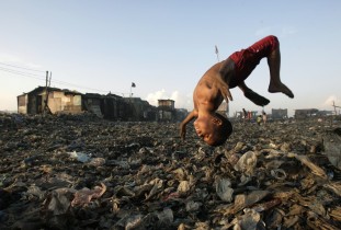 A boy plays at a garbage dump where hundreds of people stay and make a living out of recycling waste and making charcoal in the Tondo section of Manila, in 2007.